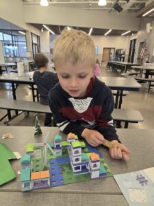 Boy looking at toys on table.