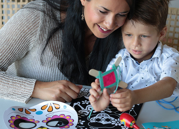 Parent with child, making a craft together