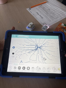 A detail shot of a an ipad with a coding activity working on it.