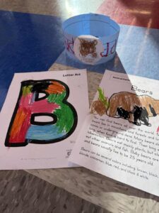 Literacy work done by students sits on table.