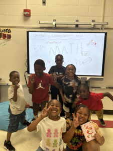 Group of students in front of a white board.